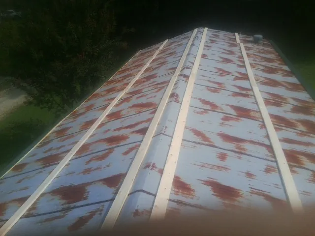Rusted metal roof panels with new wood purlins before replacement — Storm Damage Roof Repair in Sunnyvale by Roofing Brothers